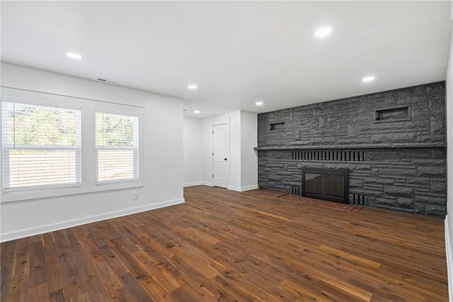 unfurnished living room with dark hardwood / wood-style floors and a fireplace