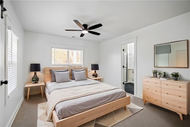 carpeted bedroom featuring ensuite bath, ceiling fan, and a barn door