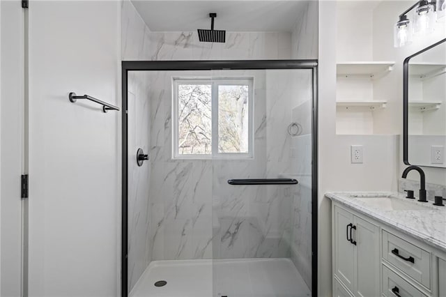 bathroom with vanity and a shower with shower door