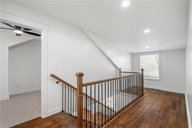 hall with vaulted ceiling and dark hardwood / wood-style floors