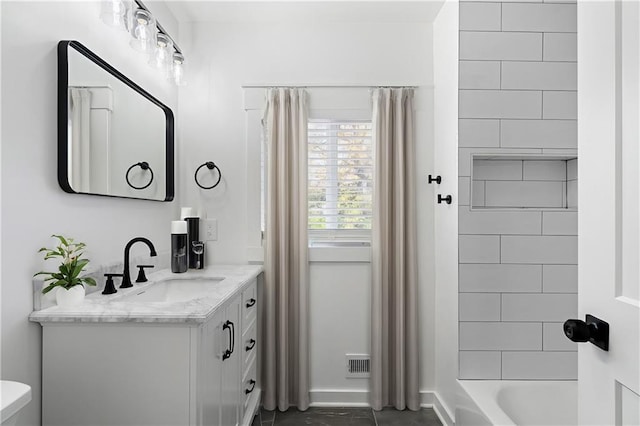 full bathroom with vanity, toilet, and tiled shower / bath