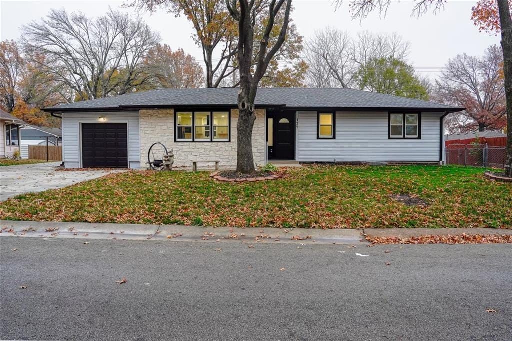 ranch-style home with a front yard and a garage