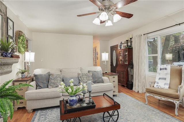 living room featuring hardwood / wood-style floors and ceiling fan