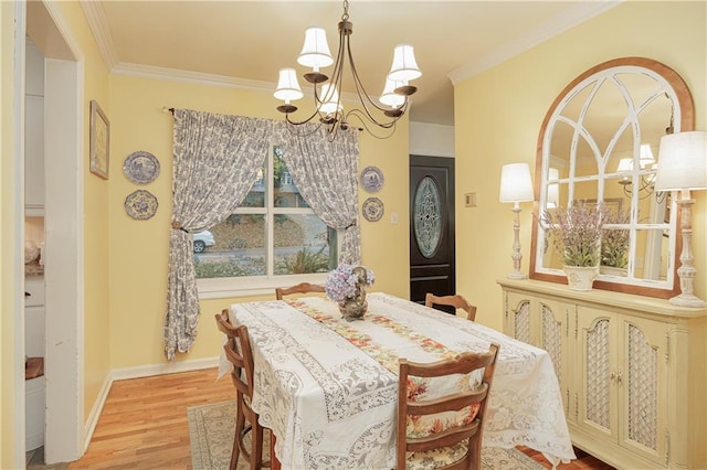 dining area featuring hardwood / wood-style floors, a notable chandelier, and ornamental molding