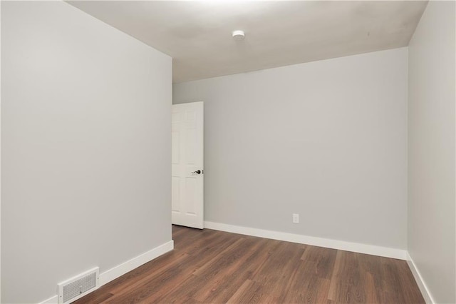 spare room with dark hardwood / wood-style flooring