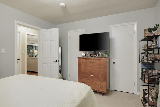 bedroom featuring light carpet