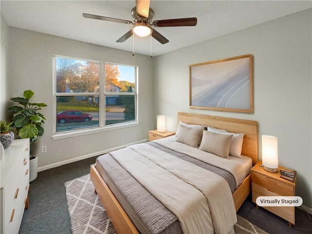 bedroom with dark colored carpet and ceiling fan