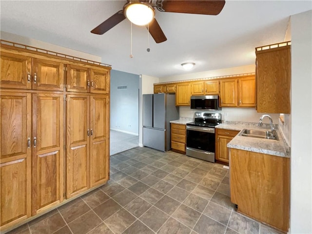 kitchen with ceiling fan, sink, and appliances with stainless steel finishes