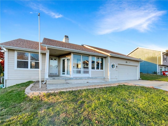 ranch-style home featuring a garage and a front lawn