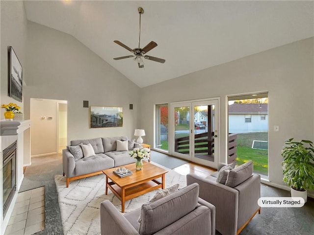 living room with ceiling fan, high vaulted ceiling, and a healthy amount of sunlight