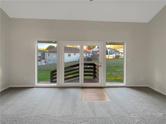 doorway to outside featuring carpet flooring