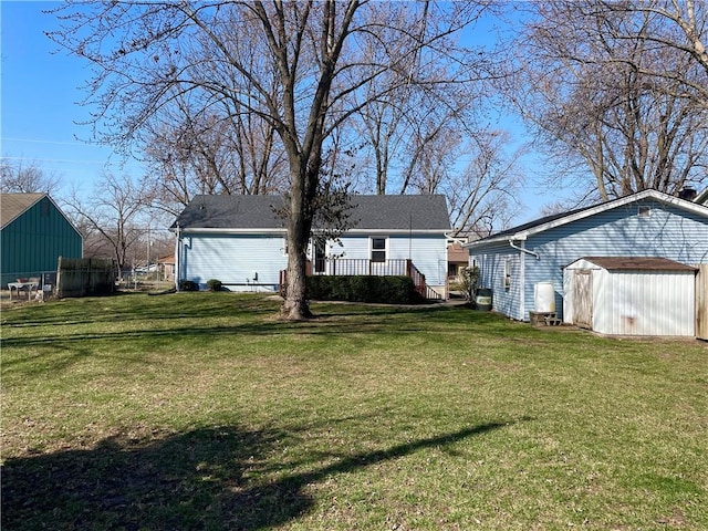 view of yard featuring a storage shed, an outdoor structure, and fence