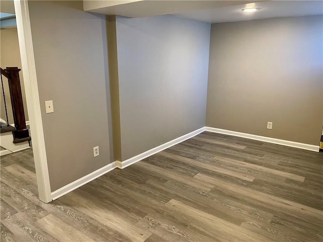 finished below grade area featuring wood finished floors and baseboards