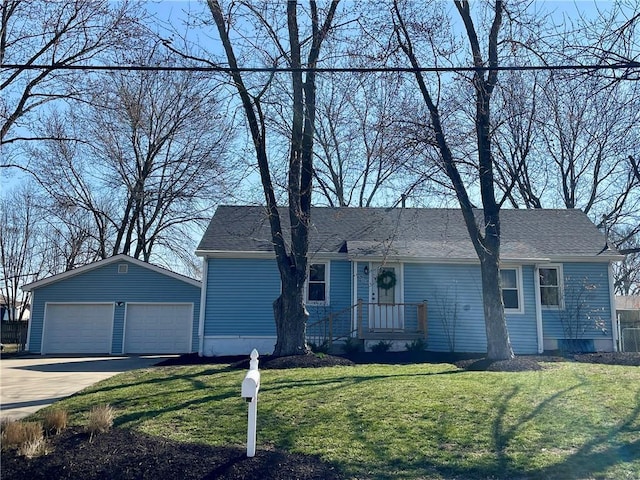 ranch-style home featuring a detached garage, an outbuilding, a front lawn, and roof with shingles