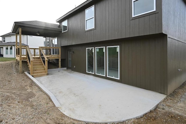 rear view of property featuring a deck and a patio