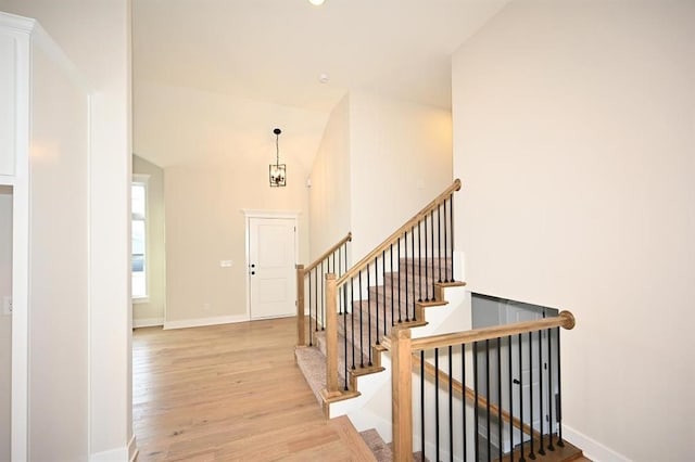 entrance foyer featuring high vaulted ceiling and light hardwood / wood-style flooring