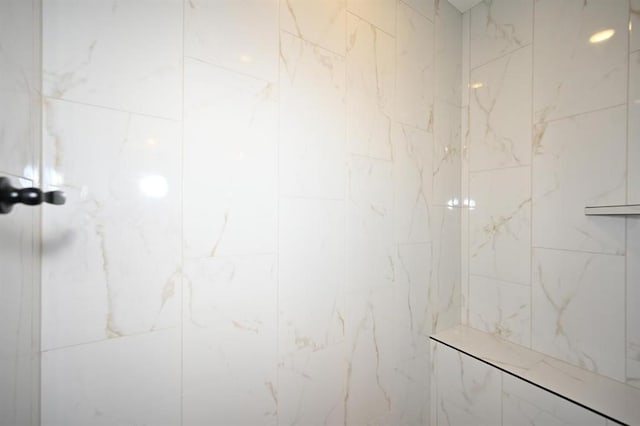 bathroom with a tile shower