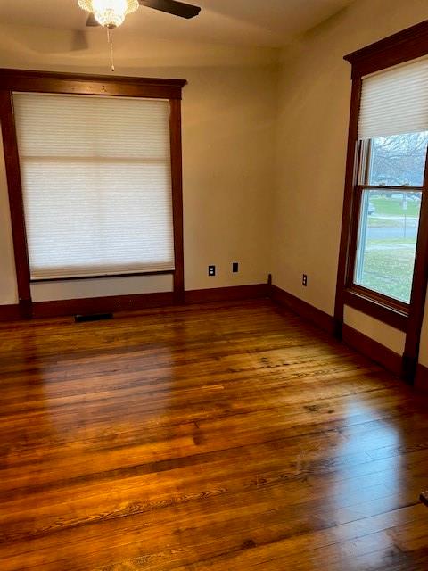 spare room featuring wood-type flooring and ceiling fan