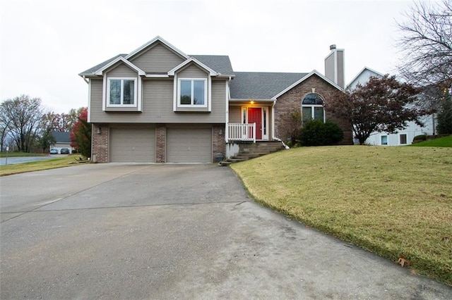 split level home with a front yard and a garage