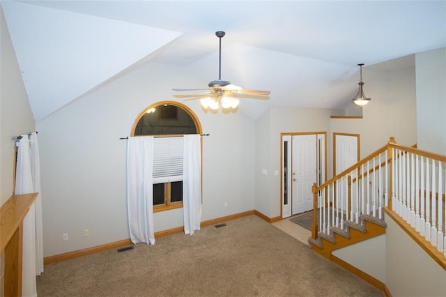 interior space with ceiling fan, light colored carpet, and vaulted ceiling