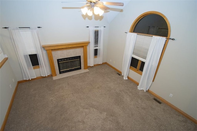 unfurnished living room with ceiling fan, a fireplace, carpet, and lofted ceiling