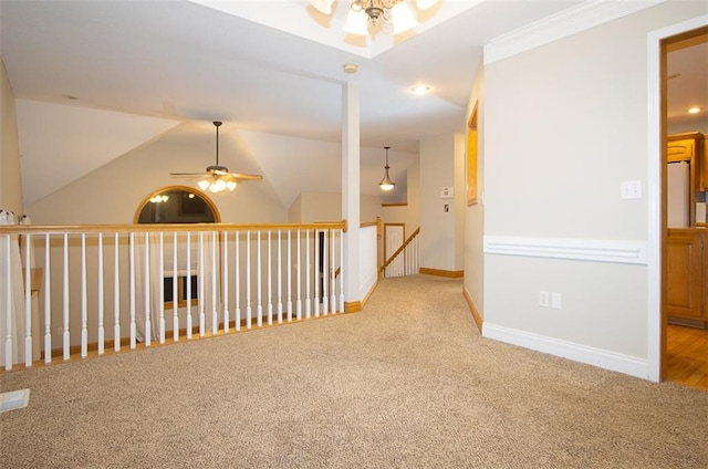 corridor featuring light colored carpet, vaulted ceiling, and ornamental molding