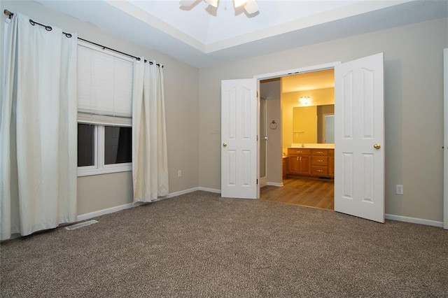 unfurnished bedroom with connected bathroom, ceiling fan, and light colored carpet