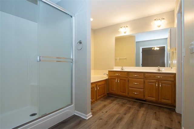 bathroom featuring separate shower and tub, vanity, and hardwood / wood-style flooring