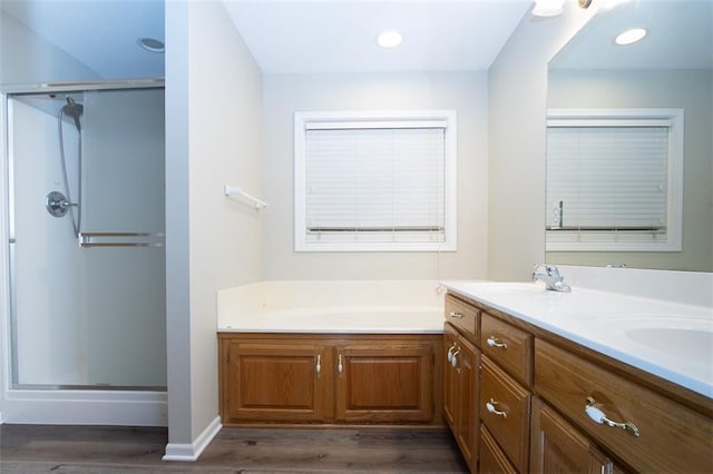 bathroom featuring vanity, independent shower and bath, and hardwood / wood-style flooring