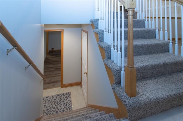 stairway with hardwood / wood-style flooring