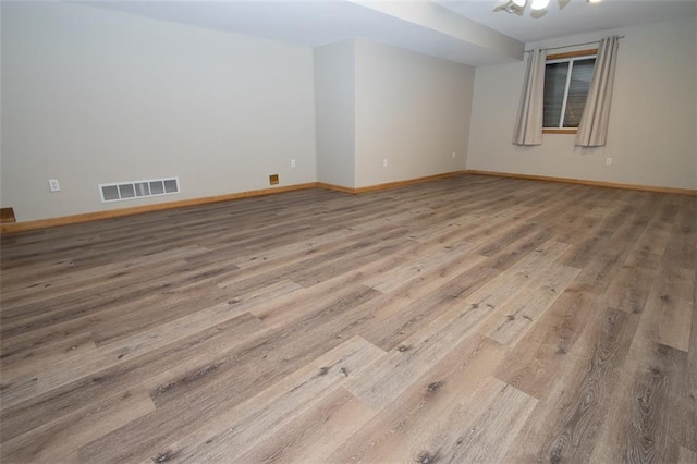 unfurnished room with wood-type flooring