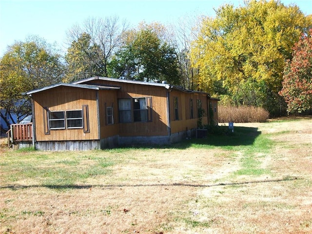 view of side of home featuring a lawn