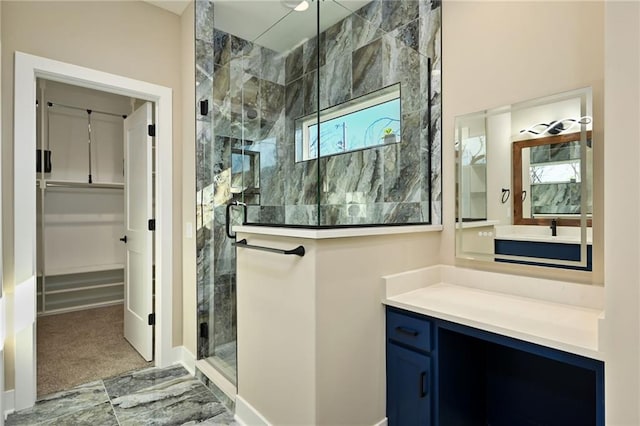 bathroom featuring vanity and a shower with door