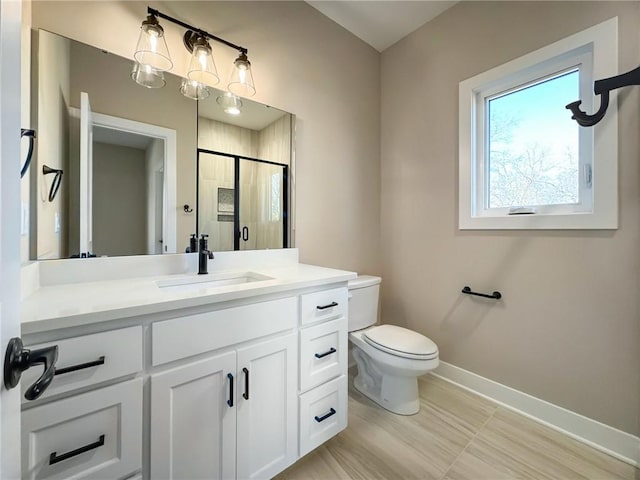 bathroom with vanity, toilet, and a shower with door