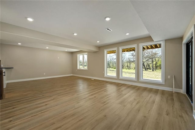 unfurnished living room with plenty of natural light and light hardwood / wood-style flooring