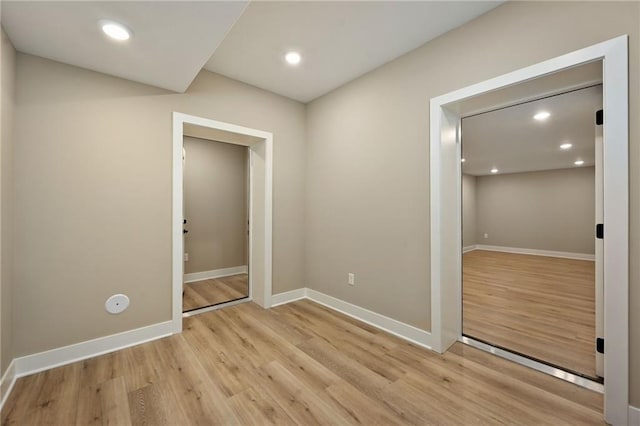 unfurnished room with light hardwood / wood-style floors