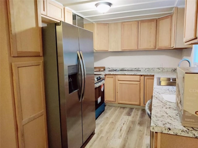 kitchen with light brown cabinets, sink, light hardwood / wood-style flooring, appliances with stainless steel finishes, and light stone counters