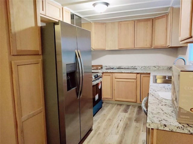 624 E 10th St, Fort Scott, KS 66701 - kitchen featuring stainless steel appliances, light brown cabinetry, light wood-style flooring, a sink, and light stone counters