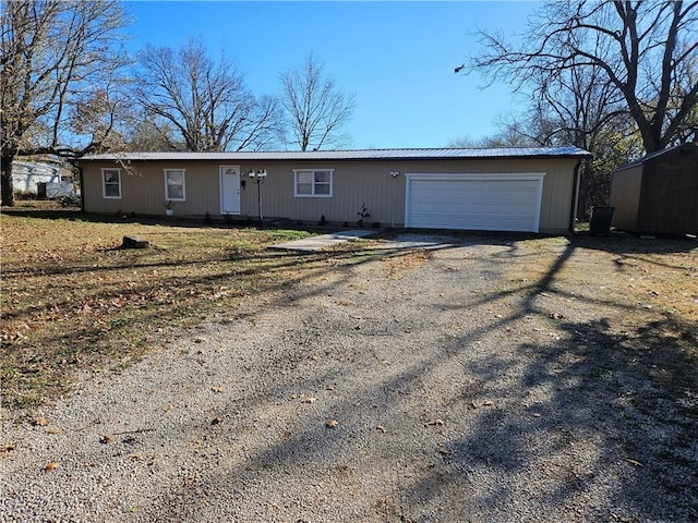 624 E 10th St, Fort Scott, KS 66701 - ranch-style home with dirt driveway, an attached garage, and metal roof