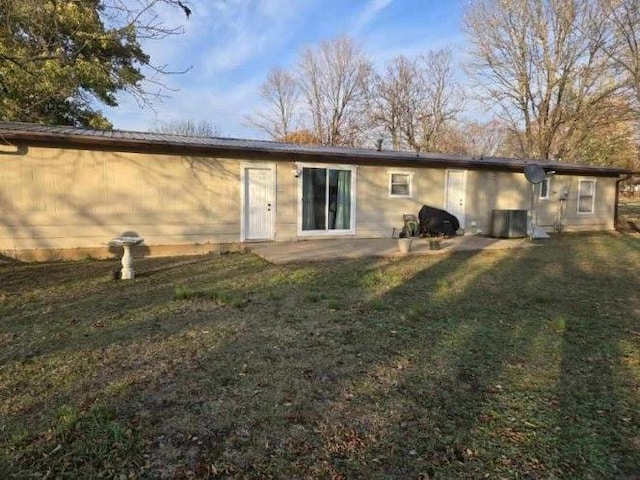 rear view of house featuring a patio area and a yard