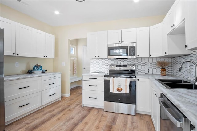 kitchen with white cabinetry and appliances with stainless steel finishes