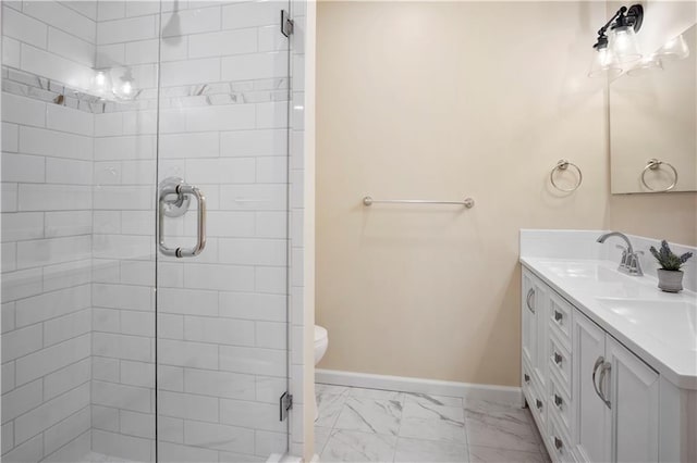 bathroom with a shower with door, vanity, and toilet