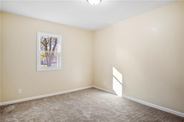 spare room featuring light colored carpet