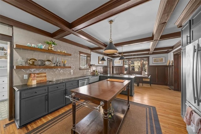 game room with a wainscoted wall, coffered ceiling, a sink, light wood-type flooring, and beam ceiling