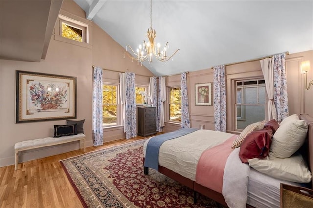 bedroom featuring light wood-style floors, multiple windows, baseboards, and a chandelier