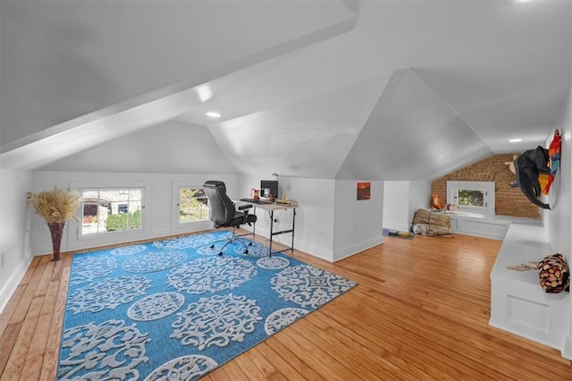 office area with vaulted ceiling, light wood-type flooring, and baseboards