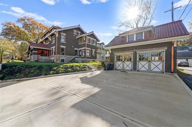 view of front of property with a garage, concrete driveway, and brick siding