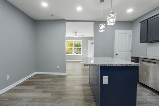 kitchen featuring a center island, dark wood-type flooring, hanging light fixtures, stainless steel dishwasher, and light stone countertops