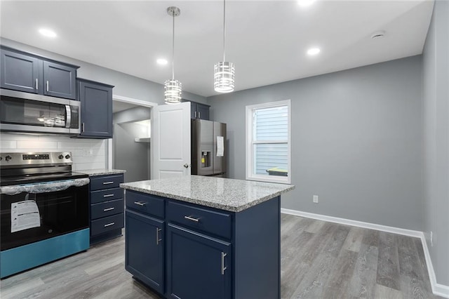 kitchen with stainless steel appliances, pendant lighting, light hardwood / wood-style floors, decorative backsplash, and a kitchen island