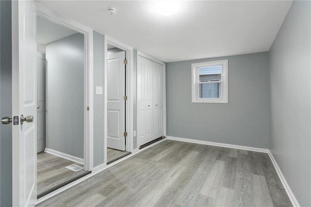 interior space featuring light wood-type flooring and a closet